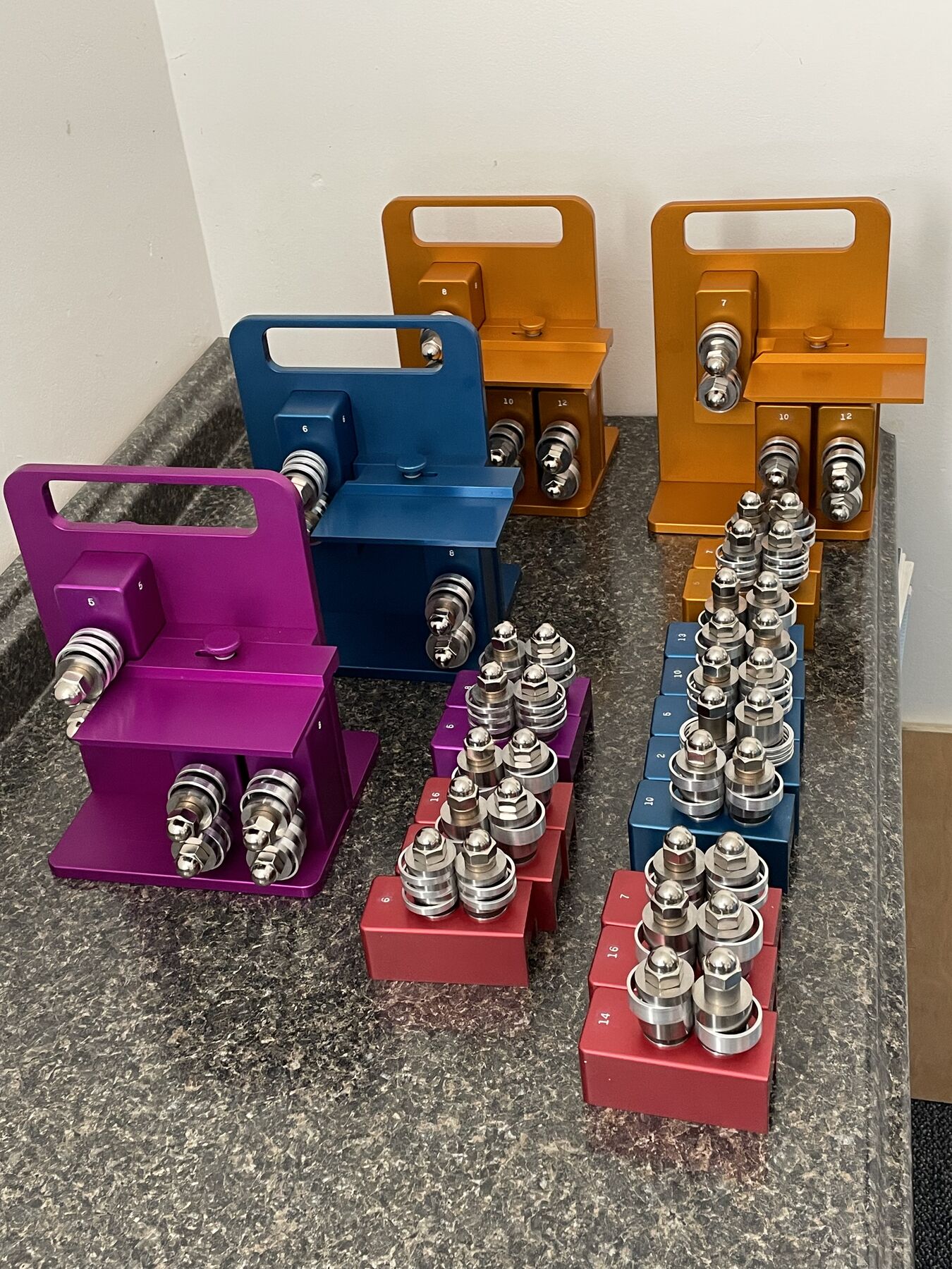 Honeydoo cutters in purple, blue and orange, with blade cartridges in red, purple, blue and orange lined up in front Honeydoo cutters in purple, blue and orange, with blade cartridges in red, purple, blue and orange lined up in front